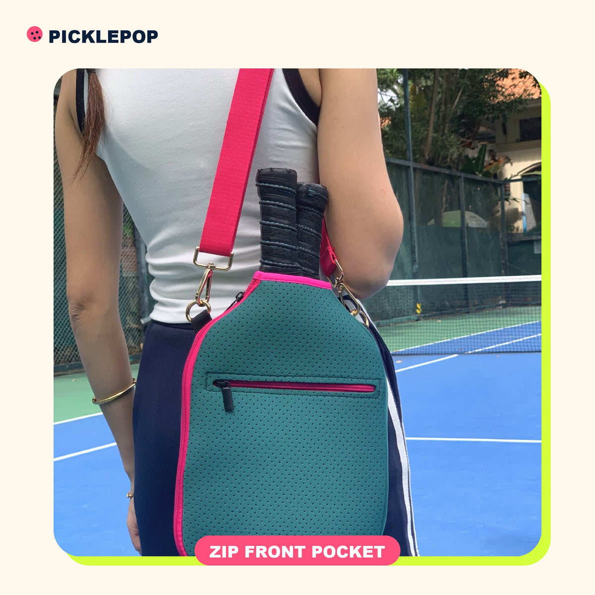 Pop Paddle Sling in Teal with pink strap, worn crossbody
